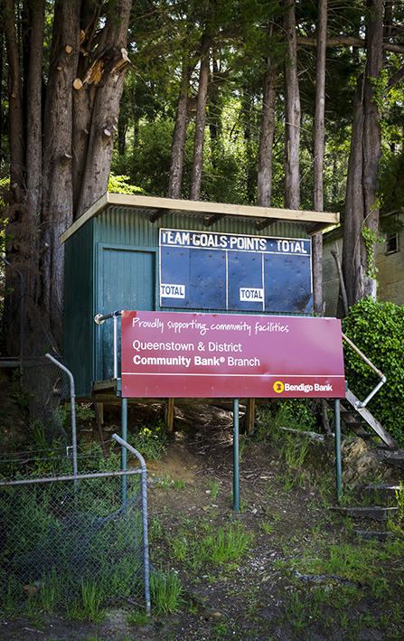 Appearances can be deceptive. This scoreboard is in a lush setting but the ground is made of gravel.